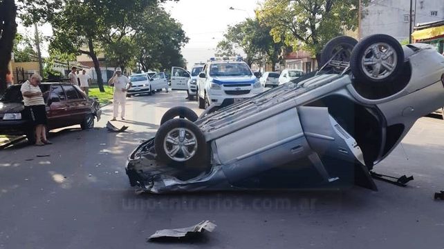 Se descompensó, chocó dos vehículo estacionados y volcó