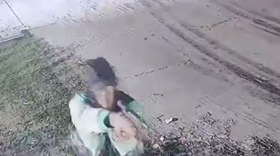 Balacera contra el frigorífico Coto. El gatillero apunta su arma contra el portón de ingreso de camiones