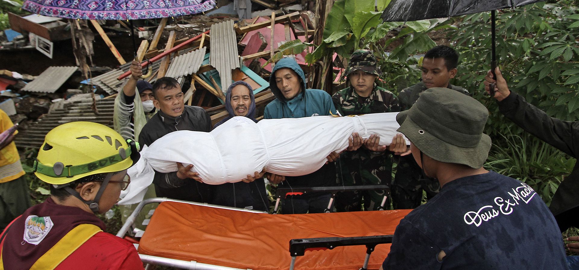 Rescatistas y familiares colocan el cuerpo de una víctima del terremoto en una camilla antes de un entierro en Cianjur, Java Occidental, Indonesia, el miércoles 23 de noviembre de 2022. Más rescatistas y voluntarios fueron desplegados el miércoles en áreas devastadas en la isla principal de Java en Indonesia para buscar a los muertos y desaparecidos de un terremoto que mató a cientos de personas.