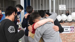 El dolor resumido en un abrazo por la muerte de la adolescente. Detr&aacute;s, los carteles con pedidos de justicia.