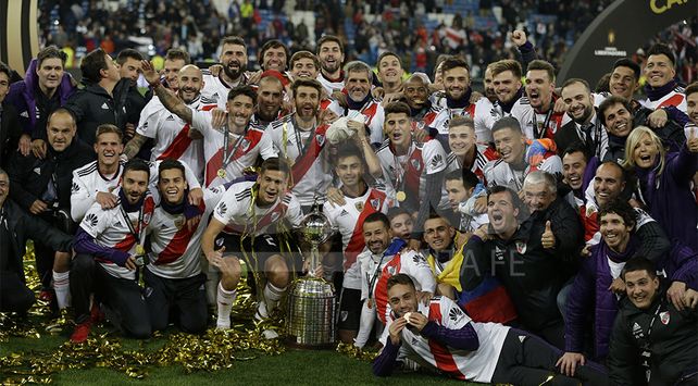 Argentina’s River Plate players pose with the trophy as they celebrate their victory in the Copa Libertadores final soccer match at the Santiago Bernabeu stadium in Madrid