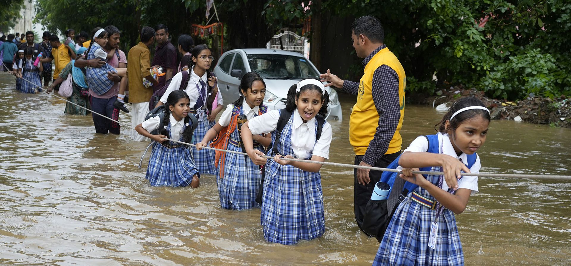 Niñas estudiantes se agarran a una cuerda mientras cruzan una calle inundada tras las fuertes lluvias, de camino a casa en Ajmer, India, el viernes 6 de septiembre de 2024. (Foto AP/Deepak Sharma) Niñas estudiantes se agarran a una cuerda mientras cruzan una calle inundada tras las fuertes lluvias, de camino a casa en Ajmer, India, el viernes 6 de septiembre de 2024. (Foto AP/Deepak Sharma)