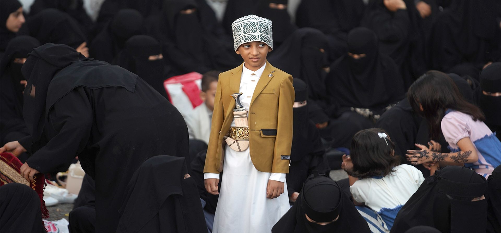 Un niño yemení vestido con ropa tradicional se encuentra cerca de un grupo de mujeres que esperan para realizar las oraciones del Eid al-Adha en la Plaza de la Libertad en Taiz, Yemen, el miércoles 27 de mayo de 2026. (Foto AP/Abdulnasser Alseddik) Un niño yemení vestido con ropa tradicional se encuentra cerca de un grupo de mujeres que esperan para realizar las oraciones del Eid al-Adha en la Plaza de la Libertad en Taiz, Yemen, el miércoles 27 de mayo de 2026. (Foto AP/Abdulnasser Alseddik)