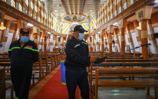 Trabajadores de la defensa civil iraquí rocían desinfectante en la Iglesia católica siríaca de Nuestra Señora de la Salvación en el distrito de Karrada. Está previsto que el Papa Francisco visite Irak del 5 al 8 de marzo de 2021.&nbsp;