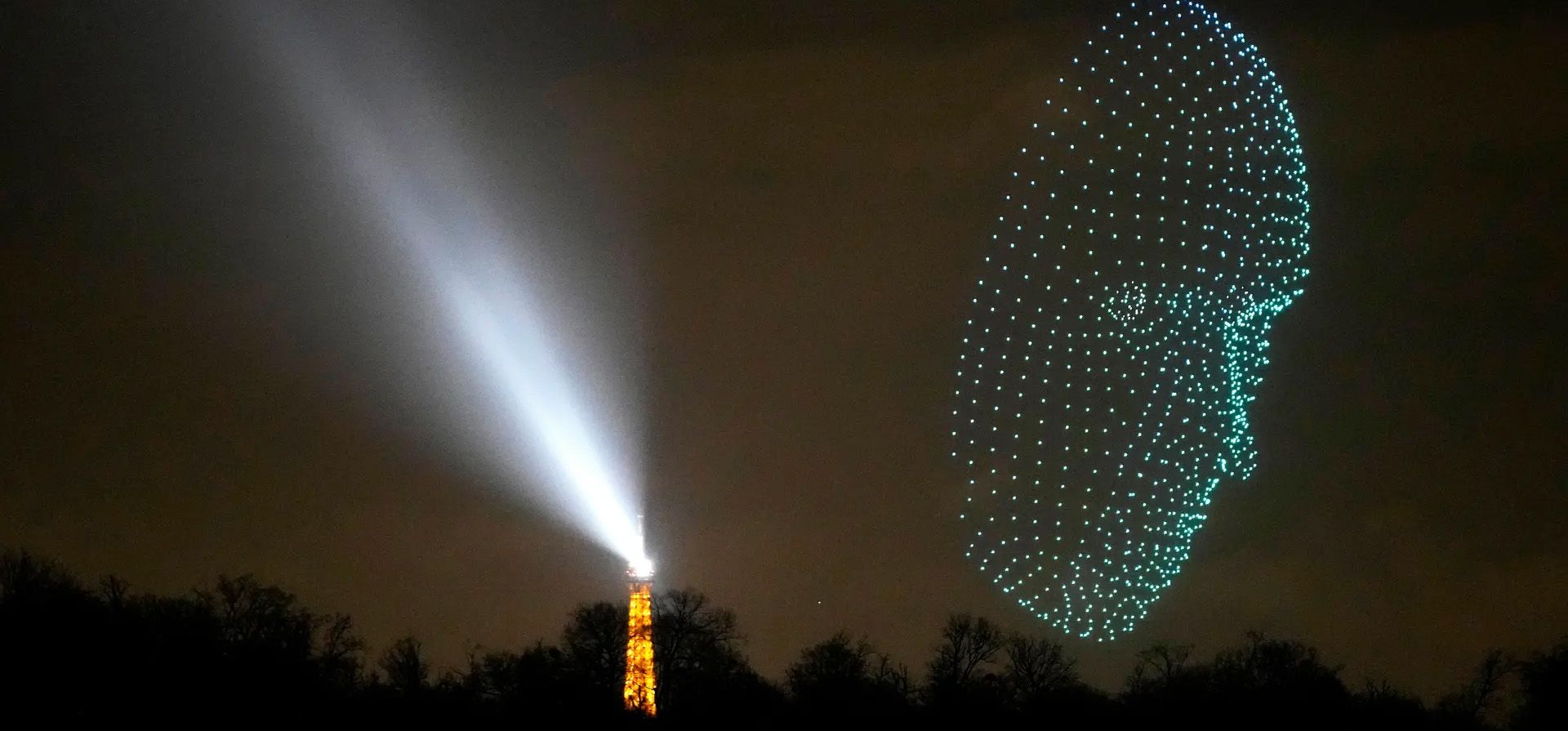 Un dron luminoso sobrevuela cerca de la Torre Eiffel, París, Francia. Fotografía: Christophe Ena/AP Un dron luminoso sobrevuela cerca de la Torre Eiffel, París, Francia. Fotografía: Christophe Ena/AP