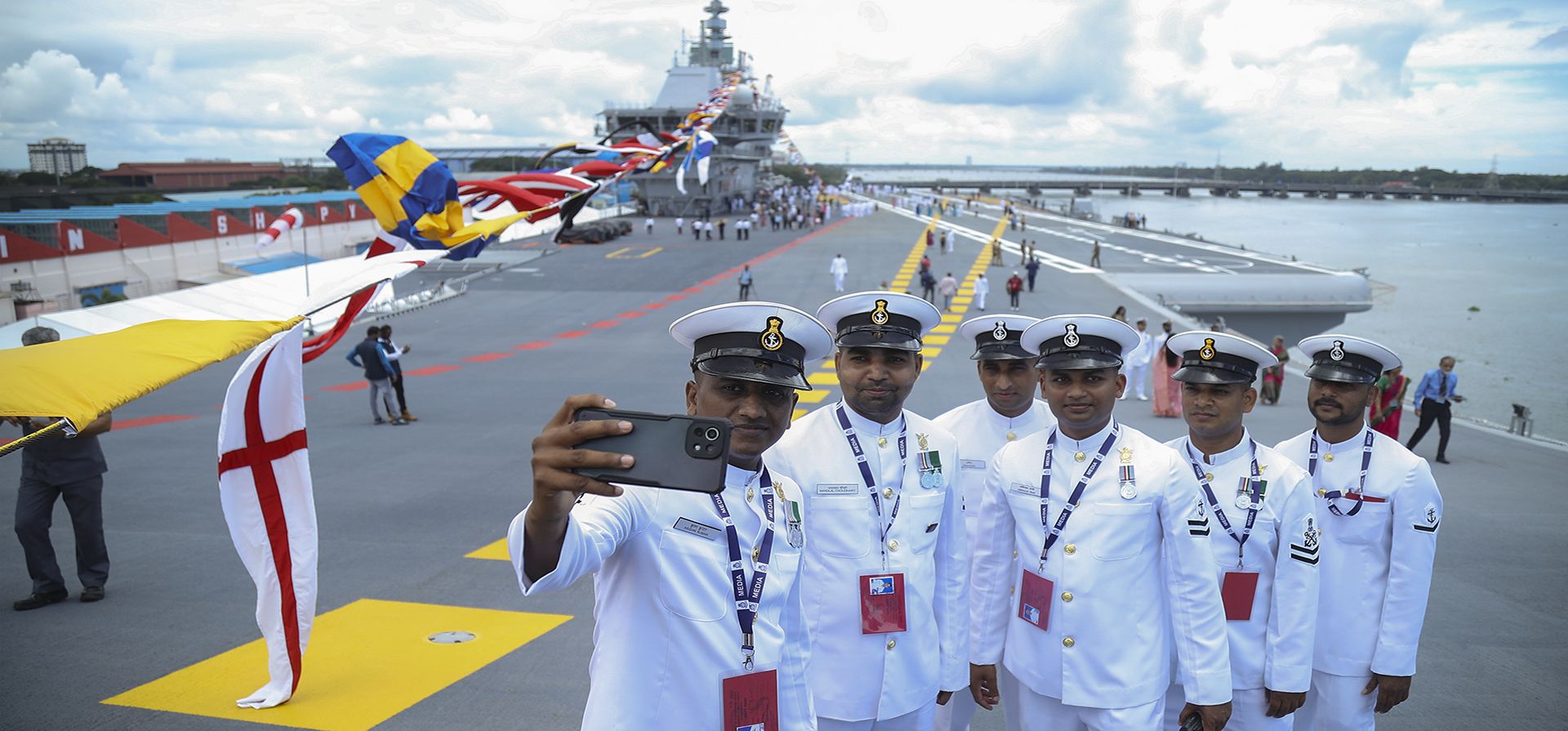 Marineros de la Armada posan para una selfie en la cubierta del primer portaaviones construido en la India, el INS Vikrant, después de que fue comisionado en Kochi, India, el viernes 2 de septiembre de 2022. El INS Vikrant, cuyo nombre es una palabra sánscrita que significa