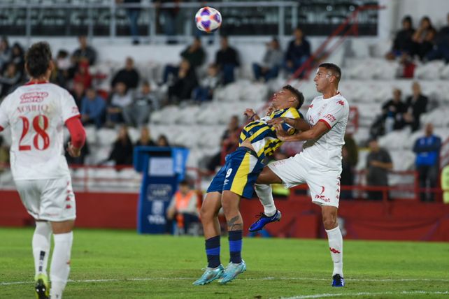 Alejo Veliz intenta proteger el balón, frente a a marca de defensor de Huracán. Central viene de hacer un buen partido.