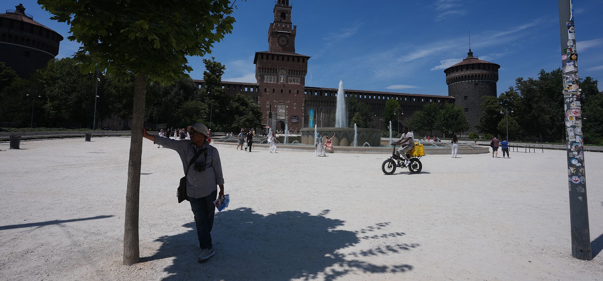 Un fotógrafo callejero espera a los clientes resguardándose del sol bajo un árbol, frente al Castillo Sforzesco en Milán, Italia, el miércoles 8 de julio de 2026. (Foto AP/Luca Bruno) Un fotógrafo callejero espera a los clientes resguardándose del sol bajo un árbol, frente al Castillo Sforzesco en Milán, Italia, el miércoles 8 de julio de 2026. (Foto AP/Luca Bruno)