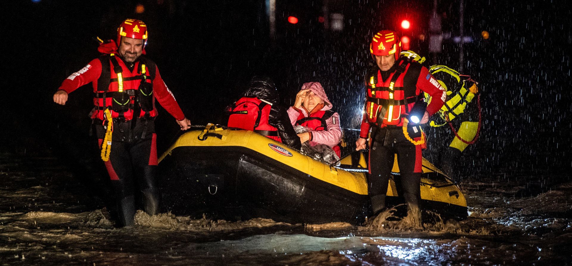 Bomberos y rescatistas de protección civil evacuan a los habitantes con un bote inflable en Forli.