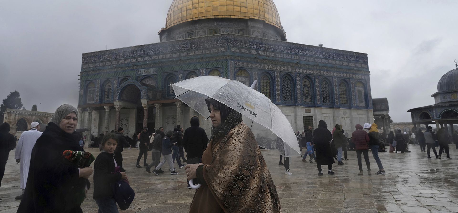 Una mujer musulmana camina con un paraguas después de las oraciones del viernes en la Mezquita de la Cúpula de la Roca en un día frío y lluvioso en el recinto de la Mezquita de Al-Aqsa en la Ciudad Vieja de Jerusalén, el viernes 6 de enero de 2023. (Foto AP/ Mahmoud illeano)