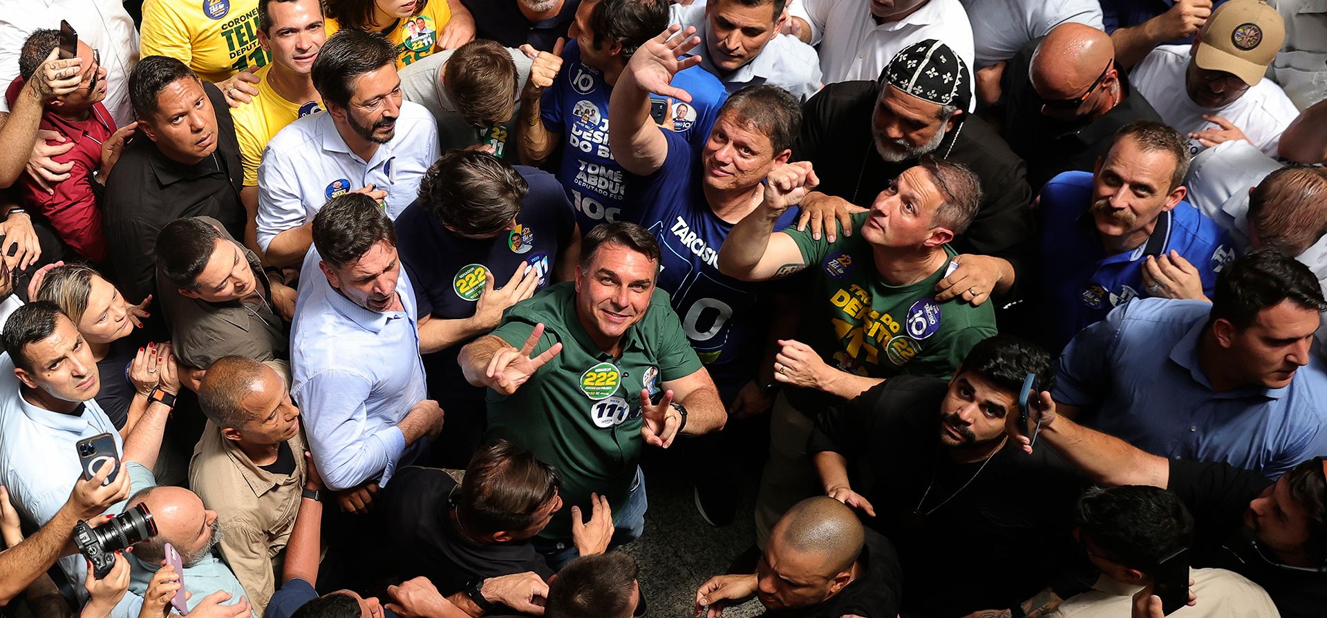 El candidato presidencial de oposición y senador Flávio Bolsonaro, centro, con una camiseta verde y mirando hacia arriba, en un acto de campaña en Sao Paulo, Brasil, el lunes 28 de septiembre de 2026. (AP Foto/Allison Sales)