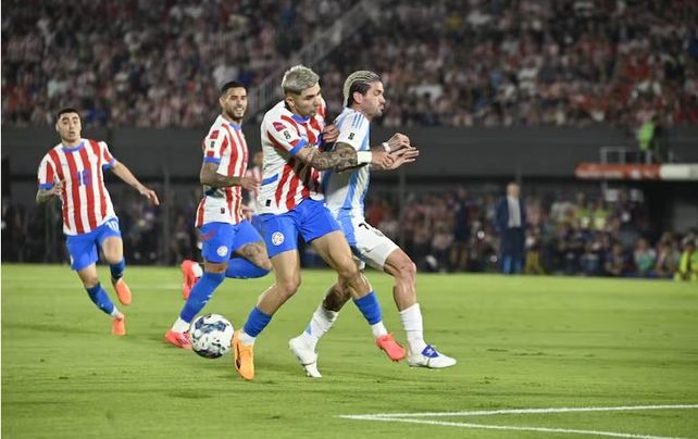 Rodrigo De Paul intenta dominar ante la marca del jugador paraguayo.