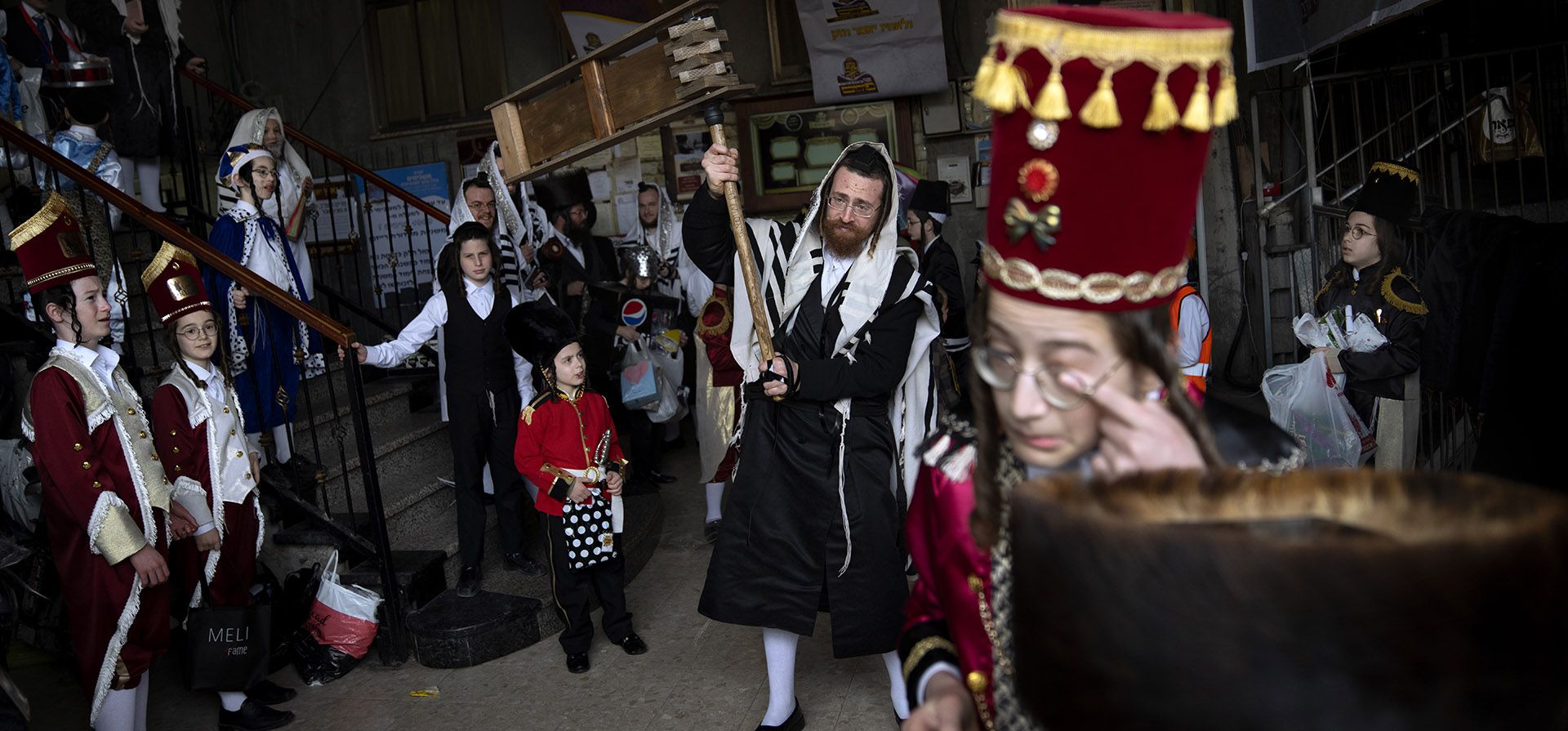 Hombres y niños judíos ultraortodoxos, algunos disfrazados, celebran la fiesta de Purim, en una sinagoga en Bnei Brak, Israel, el jueves 17 de marzo de 2022. La fiesta judía de Purim conmemora la salvación de los judíos del genocidio en la antigua Persia, como relatado en el Libro de Esther.