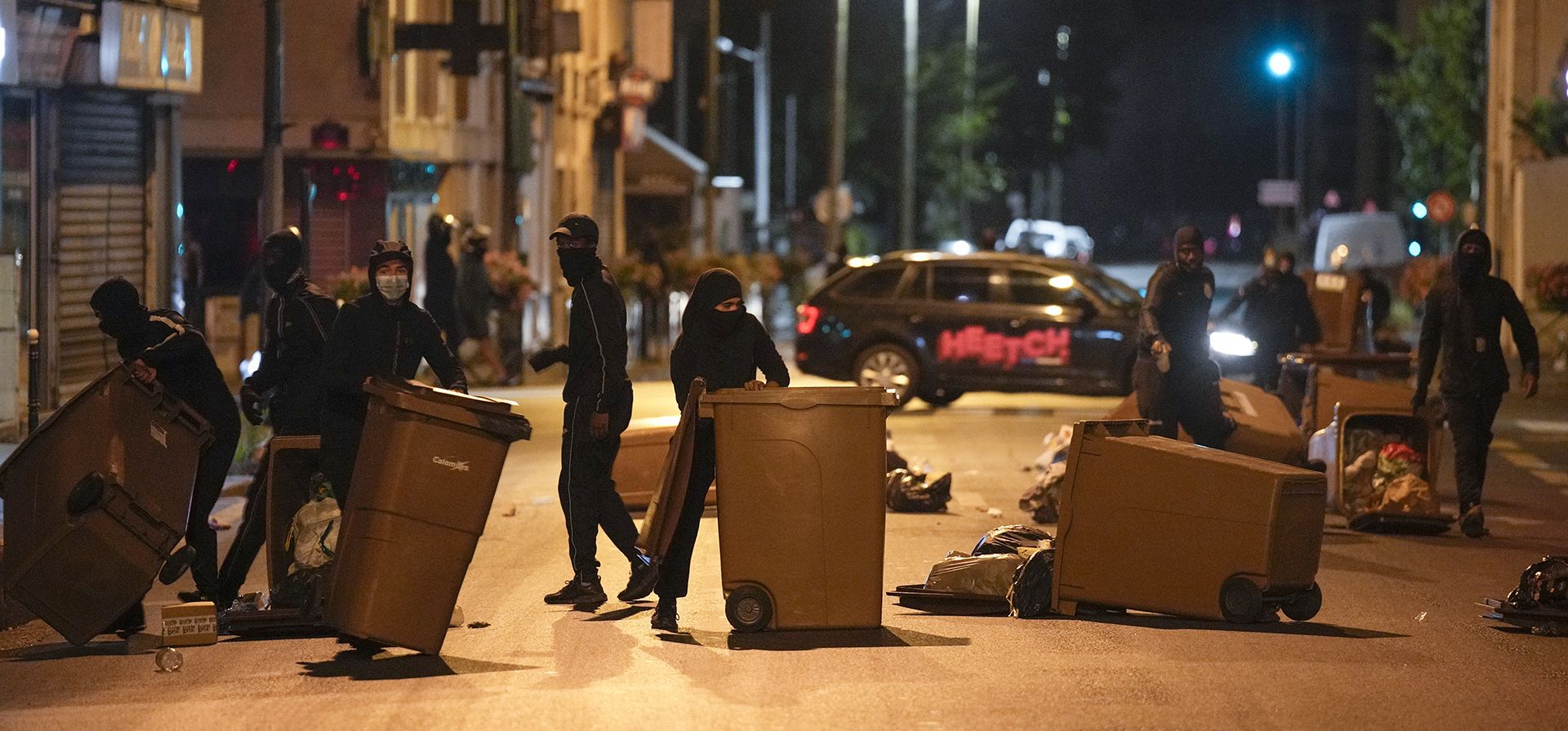 Manifestantes bloquean una calle con botes de basura en Colombes, en las afueras de París, Francia. El presidente francés, Emmanuel Macron, instó el viernes a los padres a mantener a los adolescentes en casa y propuso restricciones en las redes sociales para sofocar los disturbios que se extienden por Francia por la muerte de un conductor de 17 años a manos de la policía. (Foto AP/Lewis Joly) Manifestantes bloquean una calle con botes de basura en Colombes, en las afueras de París, Francia. El presidente francés, Emmanuel Macron, instó el viernes a los padres a mantener a los adolescentes en casa y propuso restricciones en las redes sociales para sofocar los disturbios que se extienden por Francia por la muerte de un conductor de 17 años a manos de la policía. (Foto AP/Lewis Joly)