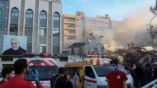 Los equipos de rescate frente a las ruinas de lo que era el consulado iraní en Damasco (Siria). A la izquierda