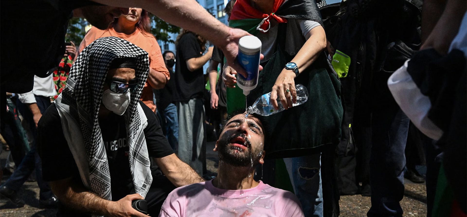 Un hombre recibe ayuda de otros manifestantes después de que la policía usara gas pimienta para dispersar una manifestación contra la visita del presidente de Israel, Isaac Herzog, Sídney, Australia. Fotografía: Saeed Khan/AFP/Getty Images Un hombre recibe ayuda de otros manifestantes después de que la policía usara gas pimienta para dispersar una manifestación contra la visita del presidente de Israel, Isaac Herzog, Sídney, Australia. Fotografía: Saeed Khan/AFP/Getty Images