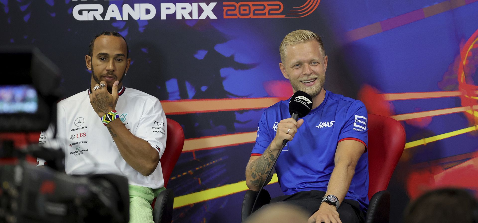 El piloto de Haas, Kevin Magnussen, de Dinamarca habla con el piloto de Mercedes, Lewis Hamilton, de Gran Bretaña, durante una conferencia de prensa antes del Gran Premio de Fórmula Uno en el circuito de Spa-Francorchamps en Spa, Bélgica, el jueves 25 de agosto de 2022.