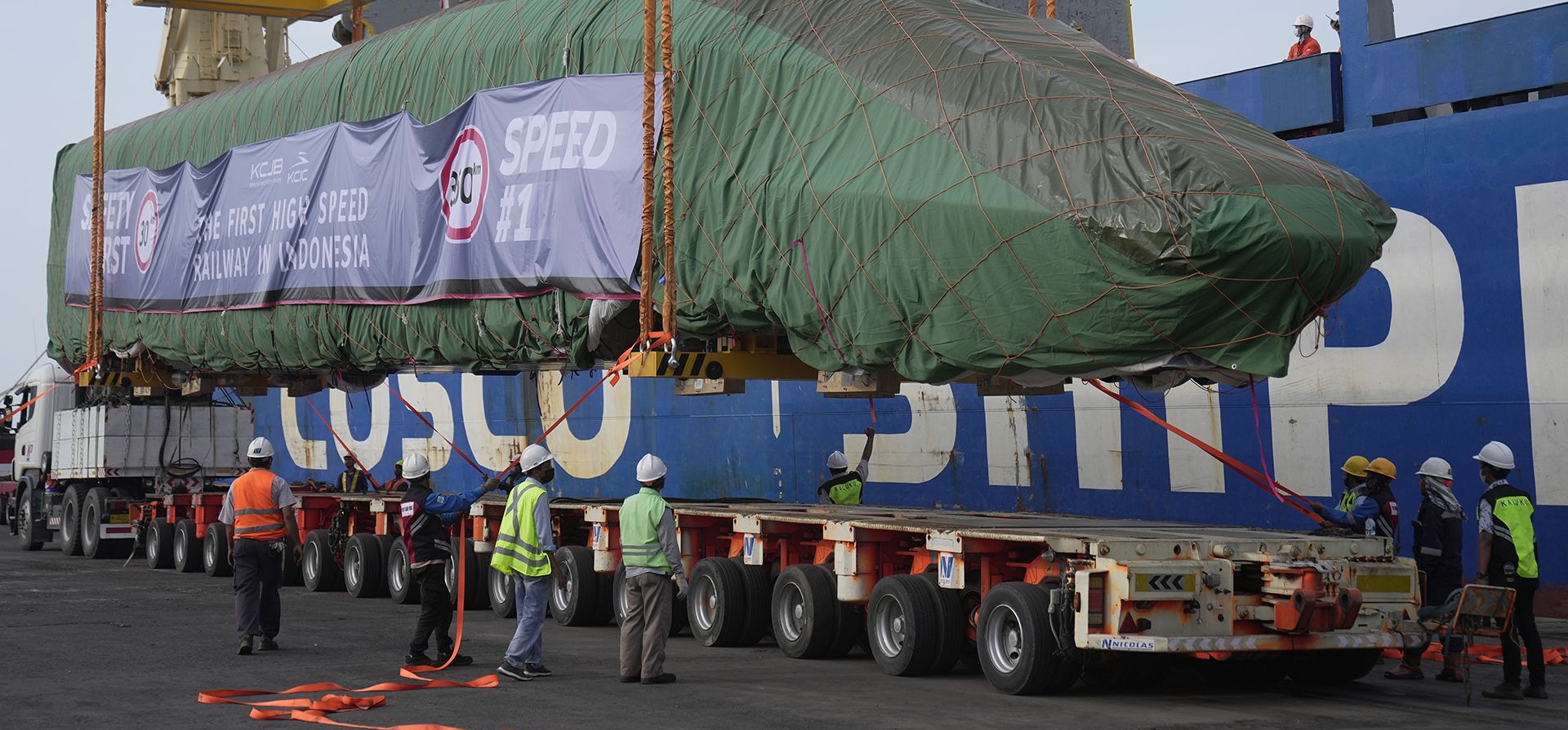 Trabajadores bajan una unidad múltiple eléctrica, parte de un tren de pasajeros de alta velocidad fabricado en China, a un camión en el puerto de Tanjung Priok en Yakarta, Indonesia, el viernes 2 de septiembre de 2022. El primer tren eléctrico de alta velocidad que está preparado para el El ferrocarril de alta velocidad Yakarta-Bandung llegó a la ciudad capital el viernes.