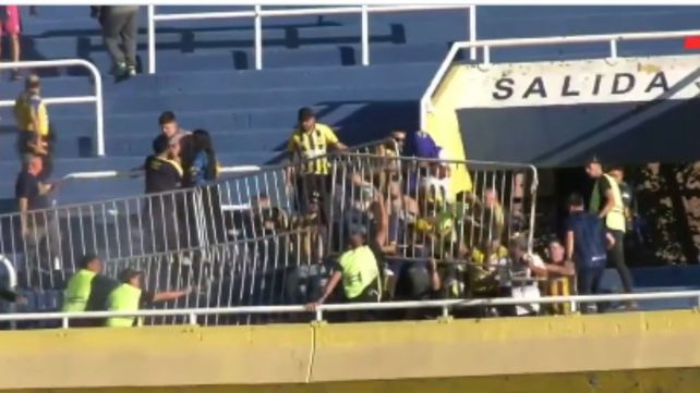 Los hinchas de Central arrojan las vallas hacia los de Peñarol. Una locura.