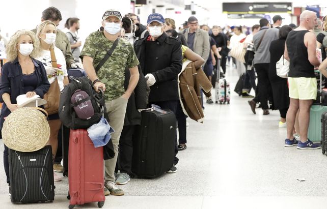 Viajeros en fila en el aeropuerto internacional de Miami. El alcalde de la ciudad dio positivo al test y está en cuarentena.&nbsp;