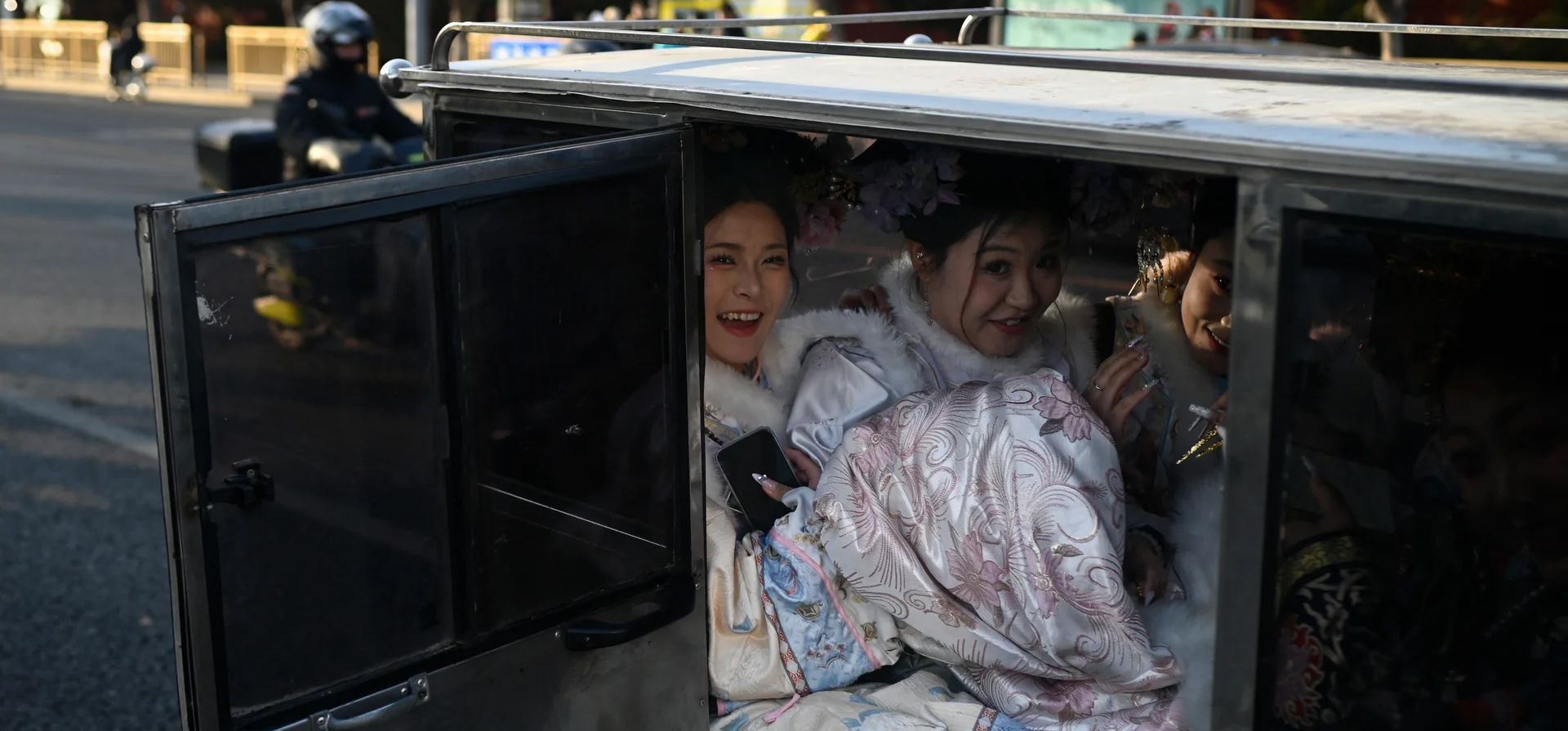 Mujeres con trajes de la dinastía Qing viajan en un triciclo eléctrico fuera de la Ciudad Prohibida, Pekín, China. Fotografía: Wang Zhao/AFP/Getty Images Mujeres con trajes de la dinastía Qing viajan en un triciclo eléctrico fuera de la Ciudad Prohibida, Pekín, China. Fotografía: Wang Zhao/AFP/Getty Images