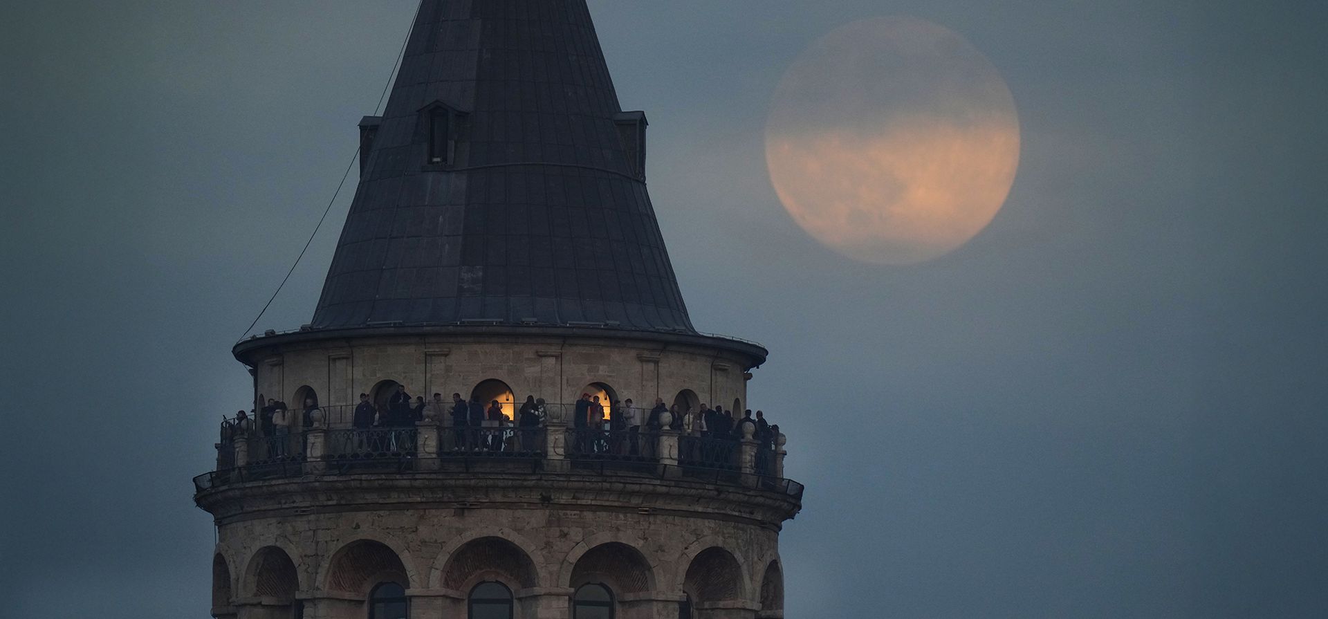 La última luna llena del año, se alza detrás de la Torre de Gálata, en Estambul, Turquía, el jueves 4 de diciembre de 2025. (Foto AP/Francisco Seco)