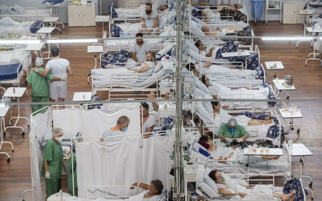 Pacientes con COVID-19 descansan en un hospital de campaña construido dentro de un coliseo deportivo en Santo Andre, en las afueras de Sao Paulo, Brasil. La propagación de COVID-19 se aceleró en 2021, causando más muertes en los primeros cuatro meses de 2021 que en todo 2020.