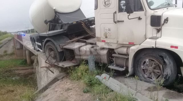 Un camión reventó una goma y quedó colgado en un puente de la 168
