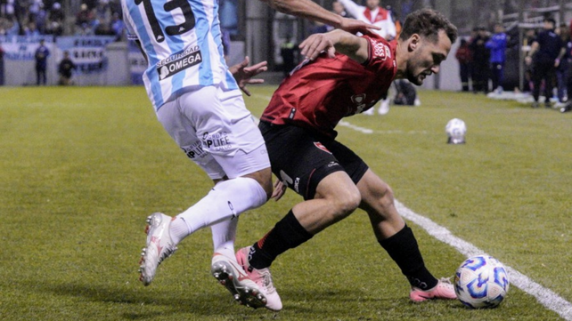 El defensor de Newells Ángelo Martino cubre la pelota.