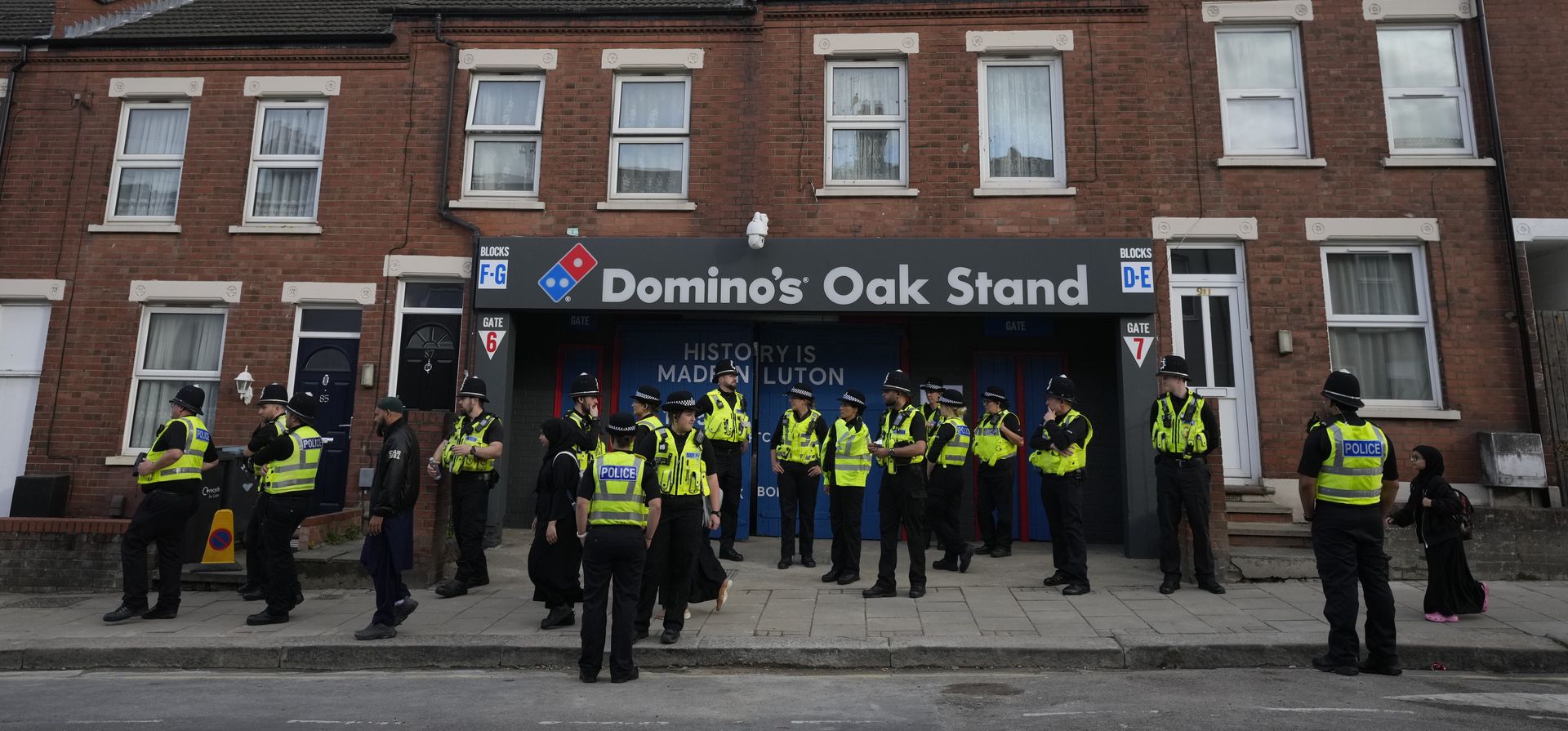 Policías se reúnen frente a la entrada de Oak Stand del Luton Town antes del partido de fútbol de la Liga Premier inglesa entre el Luton Town y el West Ham United, en Luton, Inglaterra, el viernes 1 de septiembre de 2023. (Foto AP/Frank Augstein, Archivo) Policías se reúnen frente a la entrada de Oak Stand del Luton Town antes del partido de fútbol de la Liga Premier inglesa entre el Luton Town y el West Ham United, en Luton, Inglaterra, el viernes 1 de septiembre de 2023. (Foto AP/Frank Augstein, Archivo)