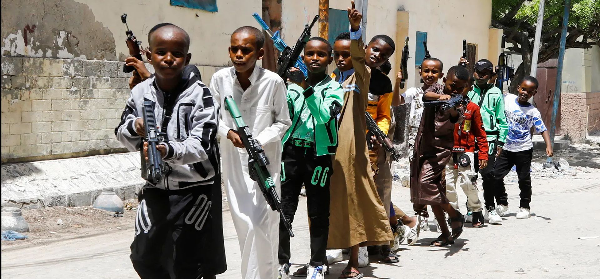 Un grupo de niños desfilan con réplicas de armas durante las celebraciones de Eid al-Fitr, que marcan el final del mes de ayuno del Ramadán, en el distrito de Waberi, Mogadiscio, Somalia. Fotografía: Feisal Omar/Reuters