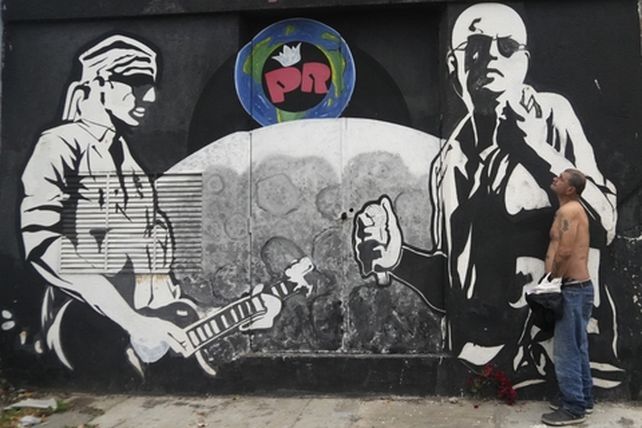 Un hombre llora frente al mural del Indio Solari en Brandazza al 2800.