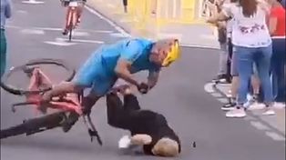 El ciclista cae al pavimento tras atropellar a la mujer que se cruzó en su camino.