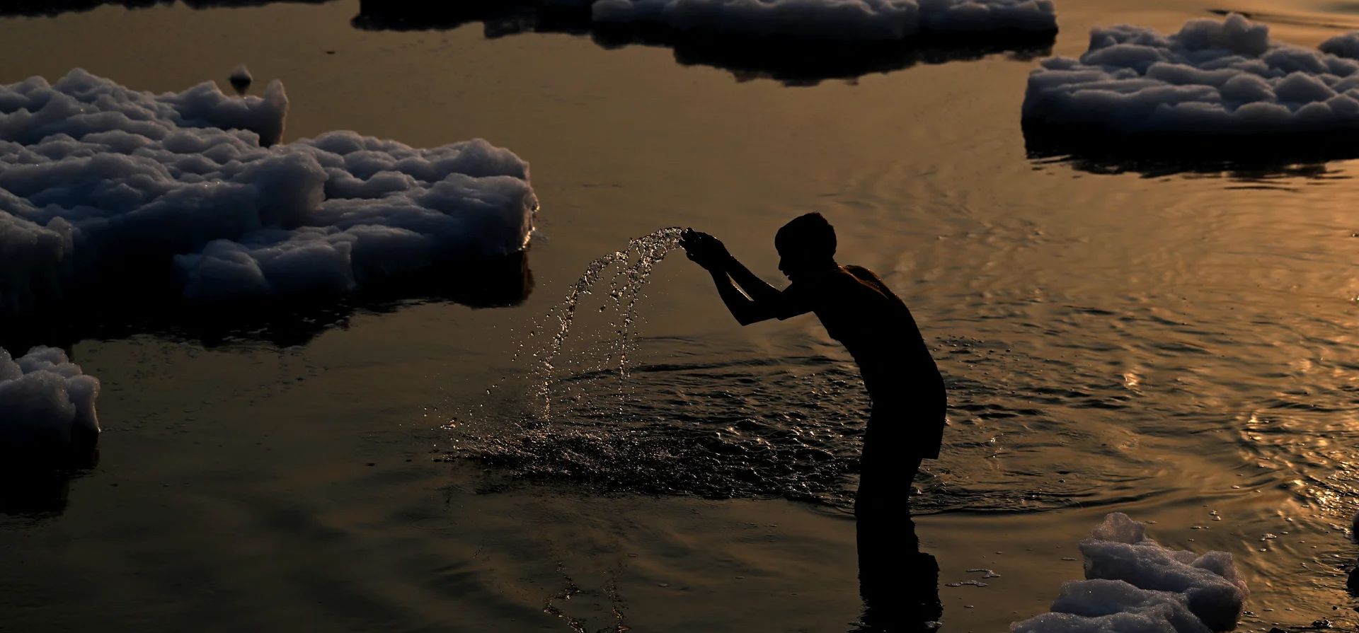 Un hombre reza en las aguas contaminadas del río Yamuna, cargadas de espuma al amanecer, Nueva Delhi, India. Fotografía: Sajjad Hussain/AFP/Getty Un hombre reza en las aguas contaminadas del río Yamuna, cargadas de espuma al amanecer, Nueva Delhi, India. Fotografía: Sajjad Hussain/AFP/Getty