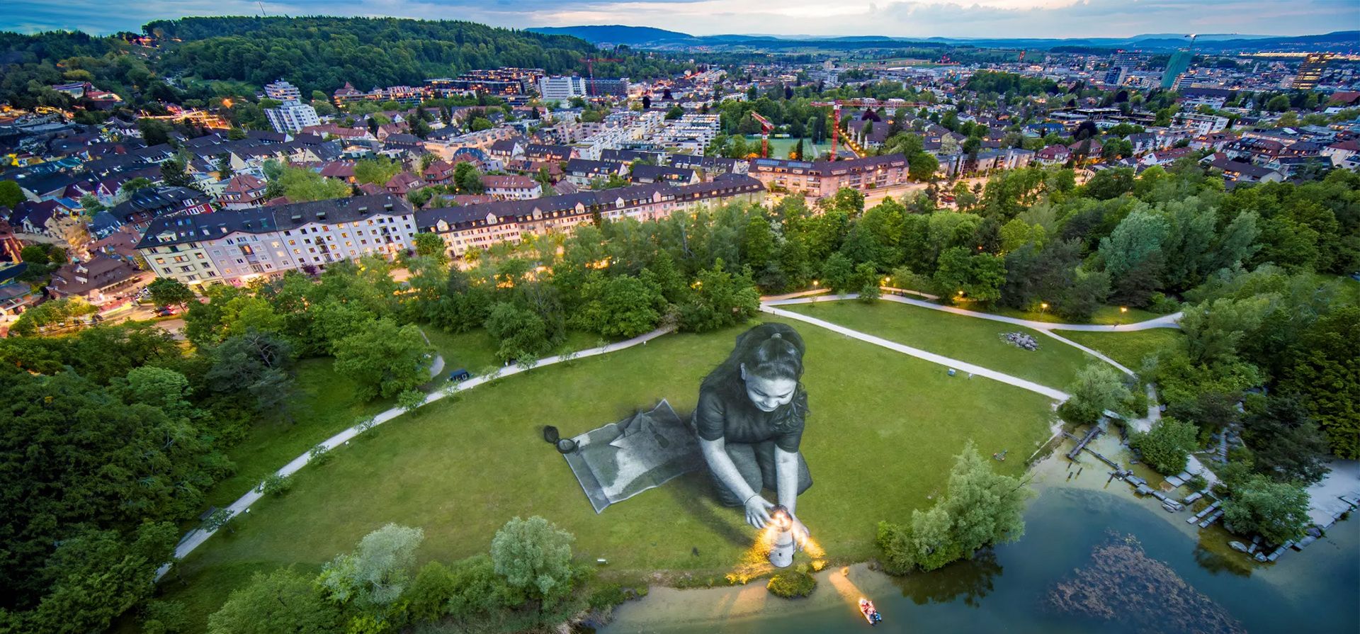 Una fotografía aérea tomada por el artista francés Guillaume Legros, también conocido como Saype, de su obra Bright Dreams, en Irchelpark. Realizada con pintura ecológica, la obra muestra a una niña rodeada de varios símbolos que evocan el rescate en el mar, en apoyo a la ONG humanitaria SOS Méditerranée Suiza, Zúrich. Fotografía: Guillaume Legros, alias Saype/AFP/Getty Images