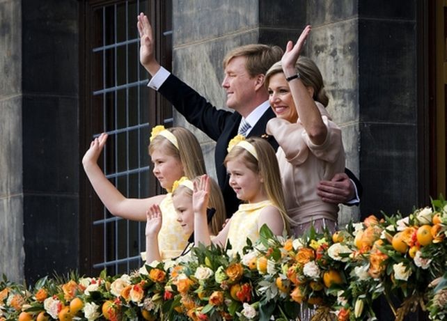 La pareja real y sus tres hijas saludan a la multitud en la Plaza Dam.