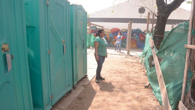 Afuera. La escuela se quedó sin baños y por eso la provincia instaló unos sanitarios químicos. En el patio se observan los tejidos de la obra inconclusa.&nbsp;