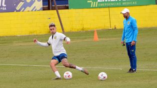 Avila impacta y el Kily González lo observa.