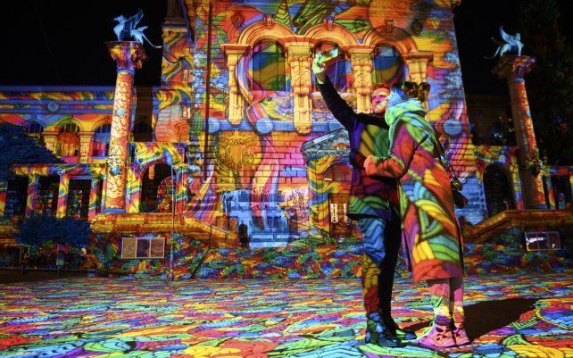 Una pareja se hace una selfie en la fachada del Palais de Rumine durante el Festival de la Luz de Lausana, Suiza. Las proyecciones iluminaran diferentes edificios con el objetivo de mostrar la ciudad de Lausana bajo una nueva luz.