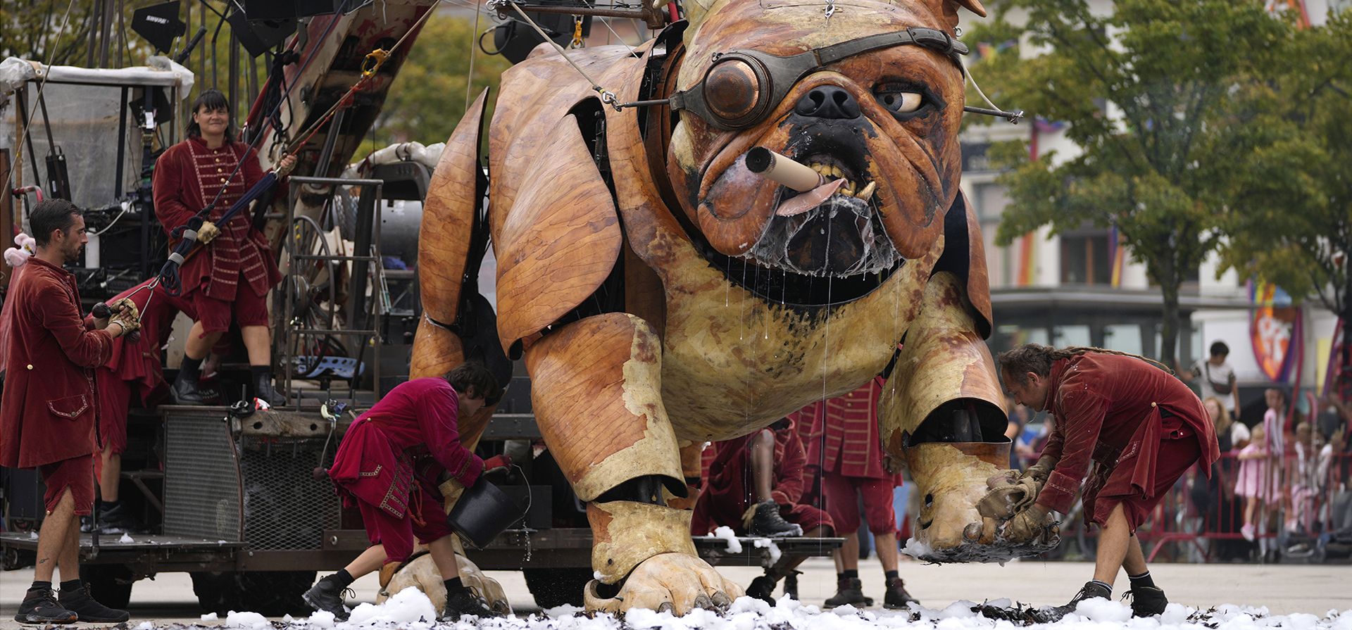 Un actor del grupo de teatro Royal de Luxe limpia la pata del títere gigante Bull Machin en Amberes, Bélgica, el viernes 25 de agosto de 2023. Como parte de las festividades del Verano de Amberes, los títeres gigantes Bull Machin y su amigo Xolo Pasee por las calles de Amberes durante tres días mientras el público en general sigue la ruta. (Foto AP/Virginia Mayo)
