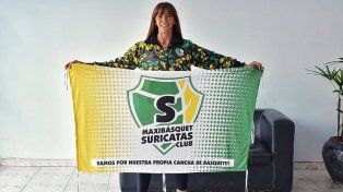 Carolina Macor, en UNO, posa con la bandera de Maxibásquet Suricatas Club. La cancha propia es el sueño de la institución.