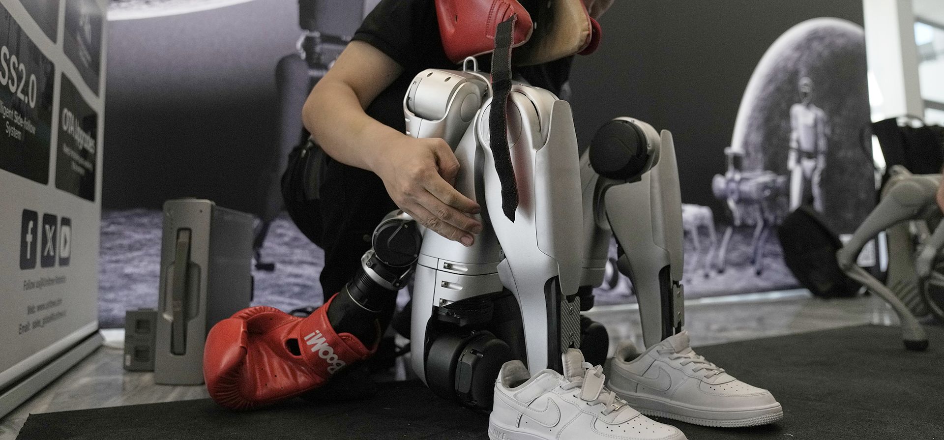 Ethan Wang, gerente de ventas de Unitree, prepara un robot G1 de la compañía para una demostración de boxeo en la primera Olimpiada Internacional Humanoide en la Academia Olímpica, en la antigua Olimpia, Grecia, el lunes 1 de septiembre de 2025. (Foto AP/Thanassis Stavrakis) Ethan Wang, gerente de ventas de Unitree, prepara un robot G1 de la compañía para una demostración de boxeo en la primera Olimpiada Internacional Humanoide en la Academia Olímpica, en la antigua Olimpia, Grecia, el lunes 1 de septiembre de 2025. (Foto AP/Thanassis Stavrakis)