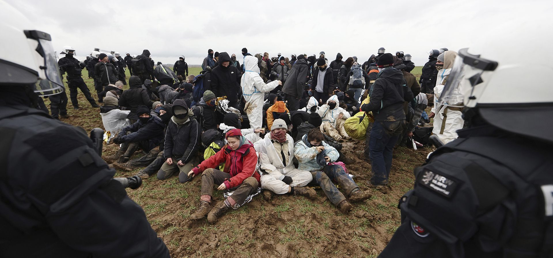 Oficiales de policía rodean a los manifestantes climáticos sentados en el suelo en el pueblo de Luetzerath cerca de Erkelenz, Alemania, el miércoles 11 de enero de 2023. (Rolf Vennenbernd/dpa vía AP)