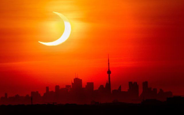 Un eclipse solar anular se eleva sobre el horizonte de Toronto, Canadá.