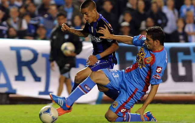 Centurión y el ex canalla Braghieri disputan la pelota.
