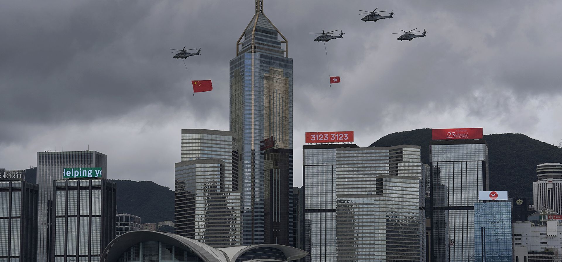 Helicópteros llevan banderas chinas y de Hong Kong para conmemorar el 25º aniversario del regreso de la antigua colonia británica al dominio chino, en Hong Kong, el viernes 1 de julio de 2022. El presidente chino, Xi Jinping, defendió el viernes su visión de "un país, dos sistemas". " marco contra las acusaciones de EE. UU., Reino Unido y otros de que Beijing ha socavado las libertades y la autonomía prometidas a Hong Kong durante 50 años.