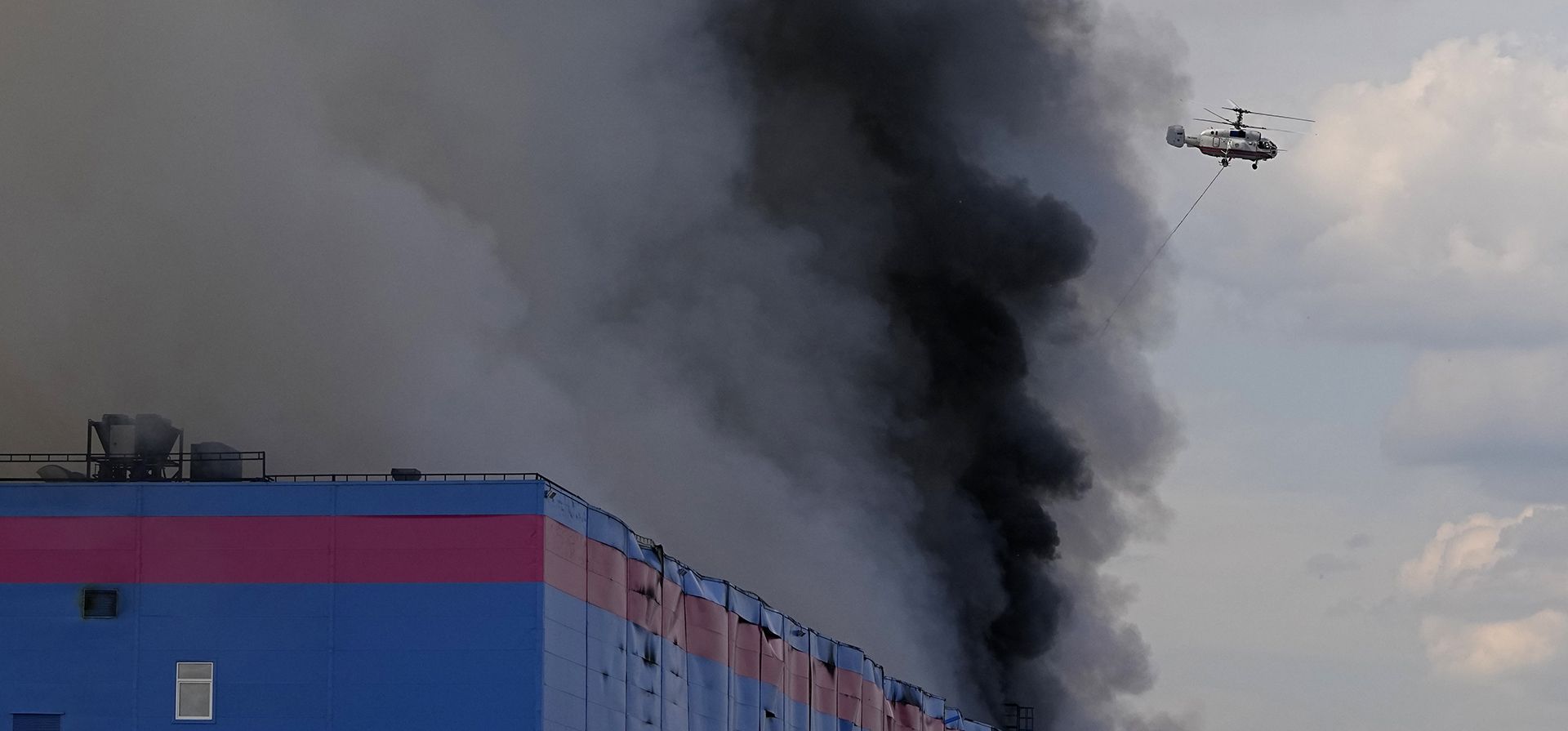 Un helicóptero extingue el fuego en un almacén del minorista en línea Ozon en el Distrito Municipal de Istra, en la región noroeste de Moscú, Rusia, el miércoles 3 de agosto de 2022.