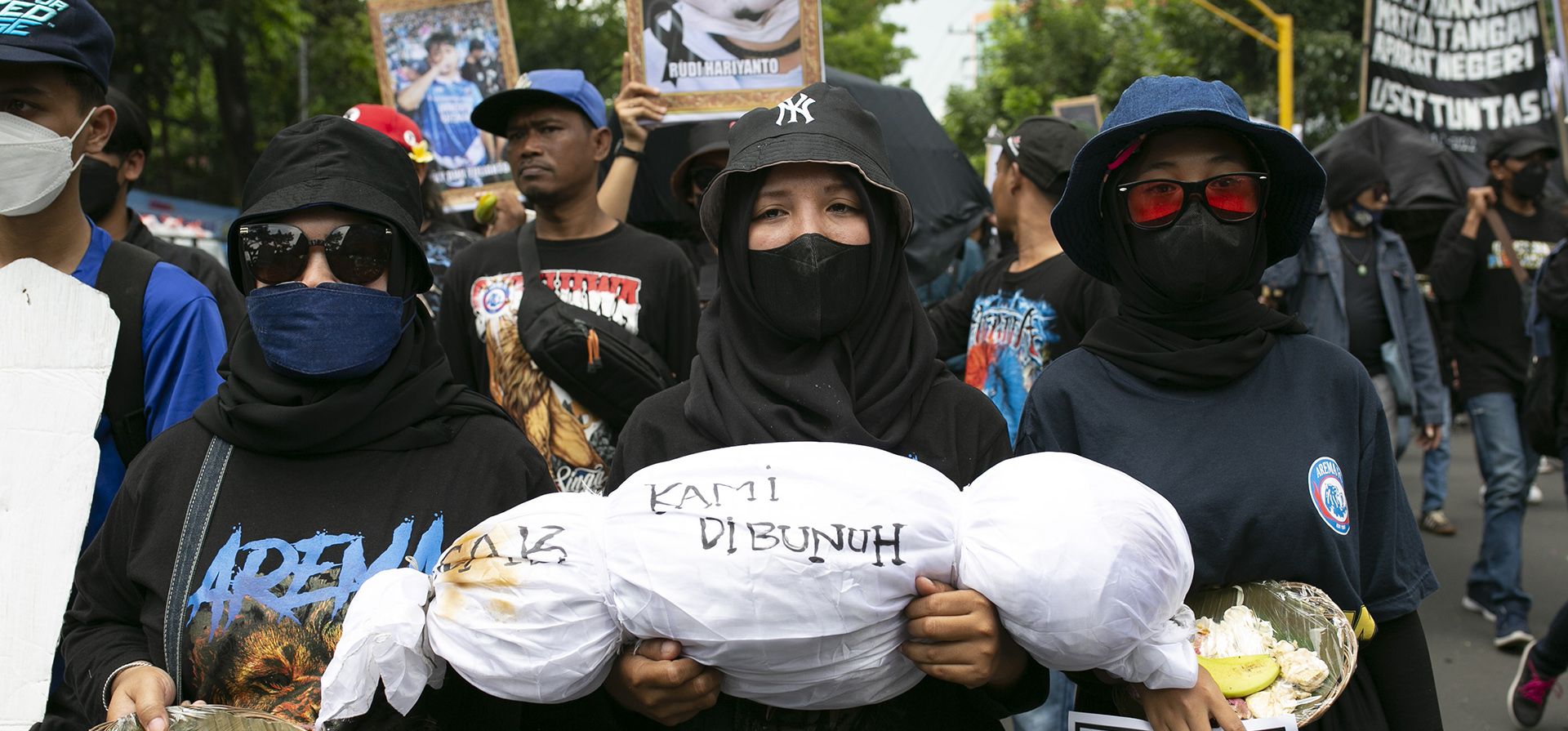 Un manifestante lleva un cadáver simulado que representa a la víctima de la estampida de fútbol del 1 de octubre, durante una manifestación que conmemora los 40 días desde la tragedia, en Malang, Java Oriental, Indonesia, el jueves 10 de noviembre de 2022.
