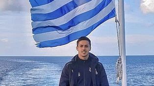 Faustino Dettler, con la bandera de Grecia de fondo.&nbsp;