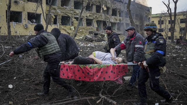 Una mujer herida durante un bombardeo en Mariupol es retirada de las calles por socorristas y soldados.&nbsp;